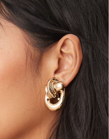 oversized earrings in knot doorknocker design in gold tone