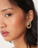 oversized earrings in knot doorknocker design in gold tone